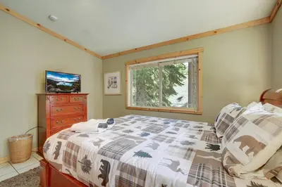 a bedroom with a bed and a dresser and a window at TaHaus Hot Tub Pool Table Dog Friendly in South Lake Tahoe