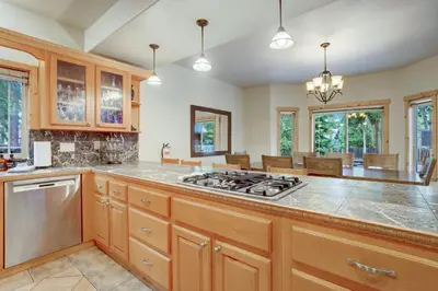 a kitchen with a stove and a counter top at TaHaus Hot Tub Pool Table Dog Friendly in South Lake Tahoe