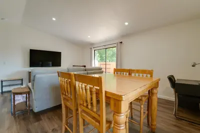 a dining room with a wooden table and a couch at Quiet Home with Yard 2 Mi to Mall and Sparks Marina! in Sparks
