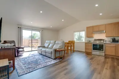 a living room with a couch and a kitchen at Quiet Home with Yard 2 Mi to Mall and Sparks Marina! in Sparks