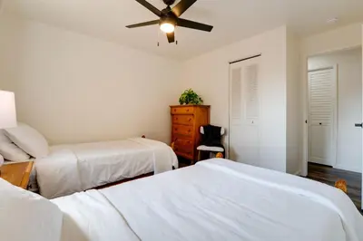 a bedroom with two beds and a ceiling fan at Quiet Home with Yard 2 Mi to Mall and Sparks Marina! in Sparks