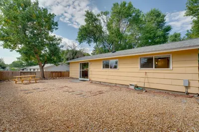 a yellow house with a picnic table in a yard at Quiet Home with Yard 2 Mi to Mall and Sparks Marina! in Sparks