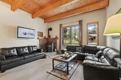 a living room with leather furniture and a fireplace at Comfort in the Sierras - Edelweiss 2BR - Kirkwood condo in Markleeville