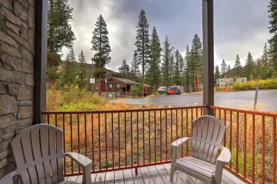 two chairs sitting on a balcony looking out at a street at Comfort in the Sierras - Edelweiss 2BR - Kirkwood condo in Markleeville