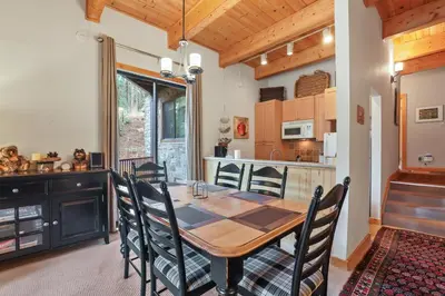 a kitchen and dining room with a wooden table and chairs at Comfort in the Sierras - Edelweiss 2BR - Kirkwood condo in Markleeville
