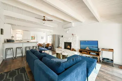 a living room with a blue couch and a fireplace at Bluejay Hideaway by Tahoe Getaways - Kings Beach 3 BR Pet Friendly w Enclosed Yard and Hot Tub in Kings Beach