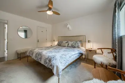 a bedroom with a bed and a ceiling fan at Bluejay Hideaway by Tahoe Getaways - Kings Beach 3 BR Pet Friendly w Enclosed Yard and Hot Tub in Kings Beach
