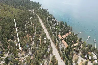 an aerial view of a beach with boats in the water at Bluejay Hideaway by Tahoe Getaways - Kings Beach 3 BR Pet Friendly w Enclosed Yard and Hot Tub in Kings Beach