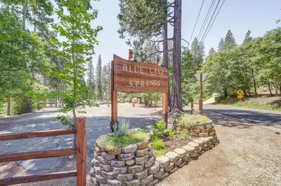 a sign for blue lake springs at a park at Sleek Blue Lake Springs Retreat with Deck and Yard! in Arnold