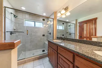a bathroom with a shower and a sink and a mirror at Twin Hollow at Dollar Point by Tahoe Getaways - 5BR w Game Room & Hot Tub in Tahoe City