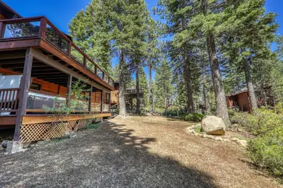 a house in the woods with a balcony at Twin Hollow at Dollar Point by Tahoe Getaways - 5BR w Game Room & Hot Tub in Tahoe City