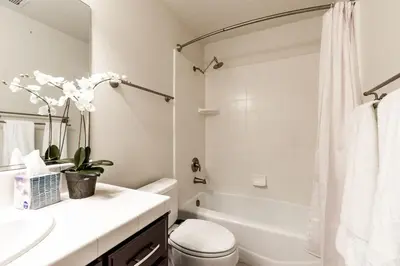a bathroom with a sink and a toilet and a tub at Yosemite and Bass lake I Hot tub I Game room I Sleeps 13 in Oakhurst