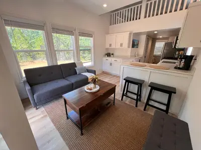 a living room with a couch and a table at Tiny Blanca at Yosemite Gateway in Groveland
