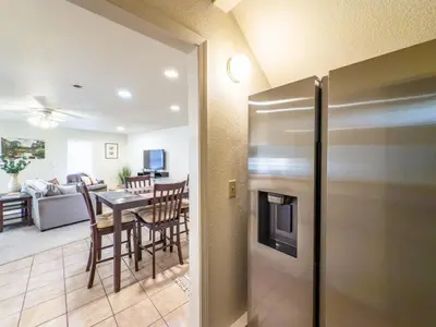 a kitchen and living room with a stainless steel refrigerator at Studio Loft Near Yosemite with Kitchenette in Oakhurst