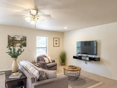 a living room with a couch and a tv at Studio Loft Near Yosemite with Kitchenette in Oakhurst