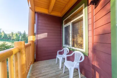 two chairs on the porch of a house at Ski in/Out 1B/1BA w/ View - Pool, Jacuzzi, Parking in Mammoth Lakes