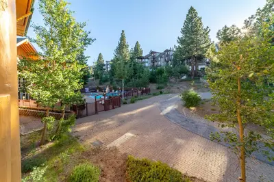 an aerial view of a driveway with trees and a fence at Ski in/Out 1B/1BA w/ View - Pool, Jacuzzi, Parking in Mammoth Lakes
