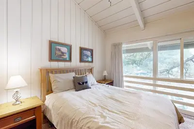 a bedroom with a bed and a large window at Sierra Park Villas 84 R in Mammoth Lakes