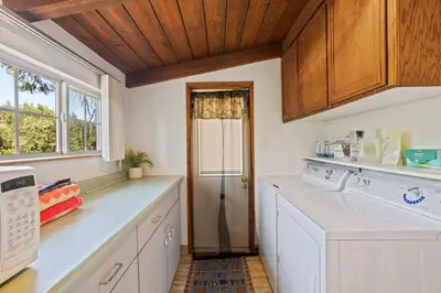 a kitchen with white appliances and a window at Red Cabin in Twain Harte - King bed in Twain Harte