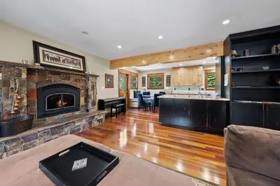 a living room with a fireplace and a kitchen at Cozy Aspen Haven - Stay for 6 in Truckee