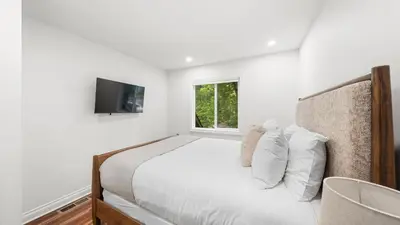 a white bedroom with a bed and a window at Cozy Forest Hideaway in Incline Village Private Balcony Sierra Solace by AvantStay in Incline Village