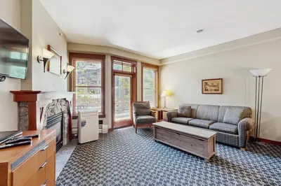 a living room with a couch and a fireplace at Ski-InandSki-Out Condo with Views in Olympic Valley in Olympic Valley