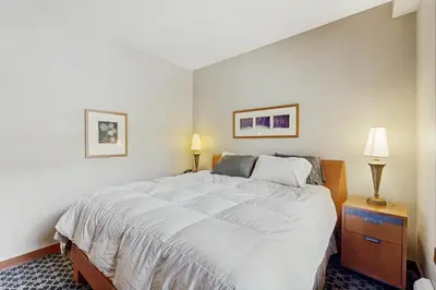 a bedroom with a large white bed and two lamps at Ski-InandSki-Out Condo with Views in Olympic Valley in Olympic Valley
