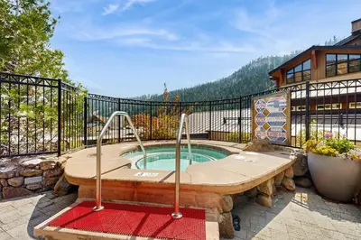 a hot tub on a balcony of a house at Ski-InandSki-Out Condo with Views in Olympic Valley in Olympic Valley