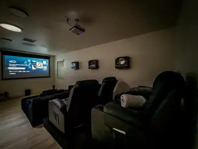 a waiting room with chairs and a flat screen tv at Yosemite Luxe Family Lodge - Spa, Theater, Sauna, EV, Game Room, Poker Table in Mariposa