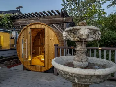 a stone fountain in front of a wooden building at Yosemite Luxe Family Lodge - Spa, Theater, Sauna, EV, Game Room, Poker Table in Mariposa