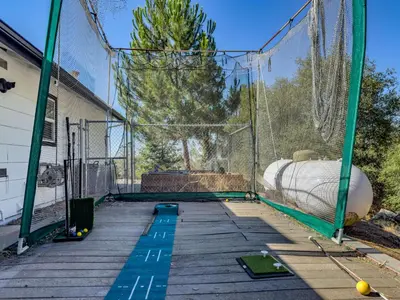 a batting cage with a bunch of balls in it at Yosemite Luxe Family Lodge - Spa, Theater, Sauna, EV, Game Room, Poker Table in Mariposa