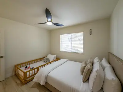 a bedroom with a bed and a ceiling fan at Yosemite Luxe Family Lodge - Spa, Theater, Sauna, EV, Game Room, Poker Table in Mariposa