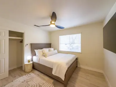 a bedroom with a bed and a ceiling fan at Yosemite Luxe Family Lodge - Spa, Theater, Sauna, EV, Game Room, Poker Table in Mariposa
