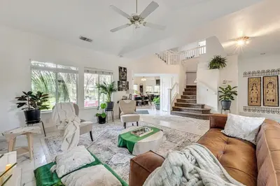 a living room with a couch and a table at Rudraksha-5BR Luxury,3Bath, NE Fresno, Shopping, Dining, Medical, Tourist Attractions in Fresno