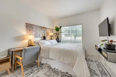 a bedroom with a large bed and a window at Rudraksha-5BR Luxury,3Bath, NE Fresno, Shopping, Dining, Medical, Tourist Attractions in Fresno