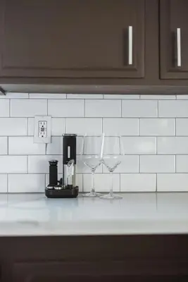 two wine glasses sitting on a kitchen counter at 7BR 3Bath in Yosemite & Bass Lake with BBQ & Hot Tub in Oakhurst
