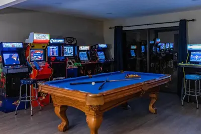 a pool table in a room with slot machines at 7BR 3Bath in Yosemite & Bass Lake with BBQ & Hot Tub in Oakhurst