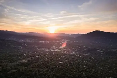 a view of a city with the sunset in the background at 7BR 3Bath in Yosemite & Bass Lake with BBQ & Hot Tub in Oakhurst