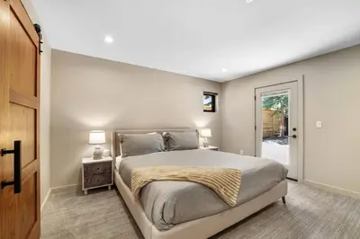 a bedroom with a large bed and a sliding door at Song of the Sierras - 4 Bed, 4 Bath Luxury Tahoe Home in South Lake Tahoe