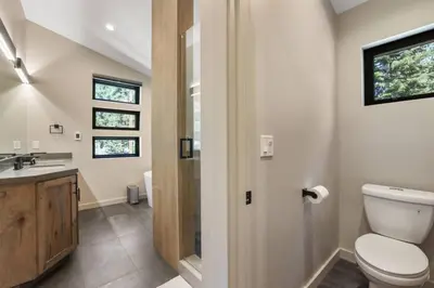 a bathroom with a toilet and a sink at Song of the Sierras - 4 Bed, 4 Bath Luxury Tahoe Home in South Lake Tahoe