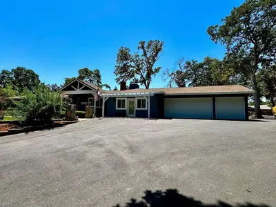 a house with a garage with a large driveway at Peaceful Country Getaway Near Casino Shopping in Placerville