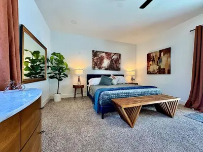 a bedroom with a bed and a table in it at Pool Remodeled 4 Bedroom Carmichael Home in Carmichael