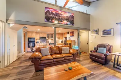 a living room with a couch and a table at Walk to Village, 1+L/2BA; Jacuzzi, Parking, W/D in Mammoth Lakes