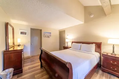 a bedroom with a large bed and two night stands at Walk to Village, 1+L/2BA; Jacuzzi, Parking, W/D in Mammoth Lakes