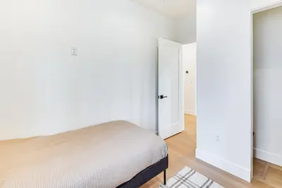 a bedroom with white walls and a bed in it at 4 Mi to Soda Springs Resort Hot Tub Hideaway! in Soda Springs