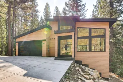a house in the woods with a driveway at 4 Mi to Soda Springs Resort Hot Tub Hideaway! in Soda Springs