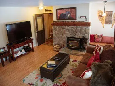 a living room with a couch and a fireplace at Amazing Gem Next to golf course with View- Pool & jacuzzi in Mammoth Lakes