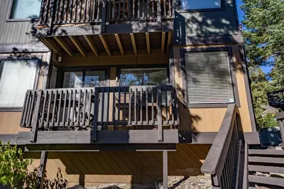 a balcony on a house with a bench on it at Amazing Gem Next to golf course with View- Pool & jacuzzi in Mammoth Lakes