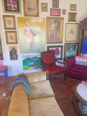 a living room with a couch and paintings on the wall at Heidi's Artistic Abode in Three Rivers