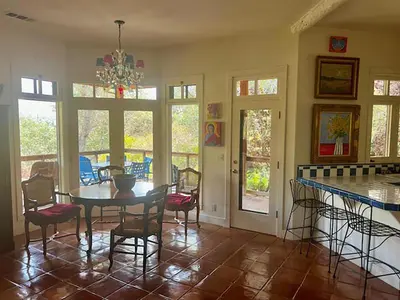 a dining room with a table and chairs at Heidi's Artistic Abode in Three Rivers